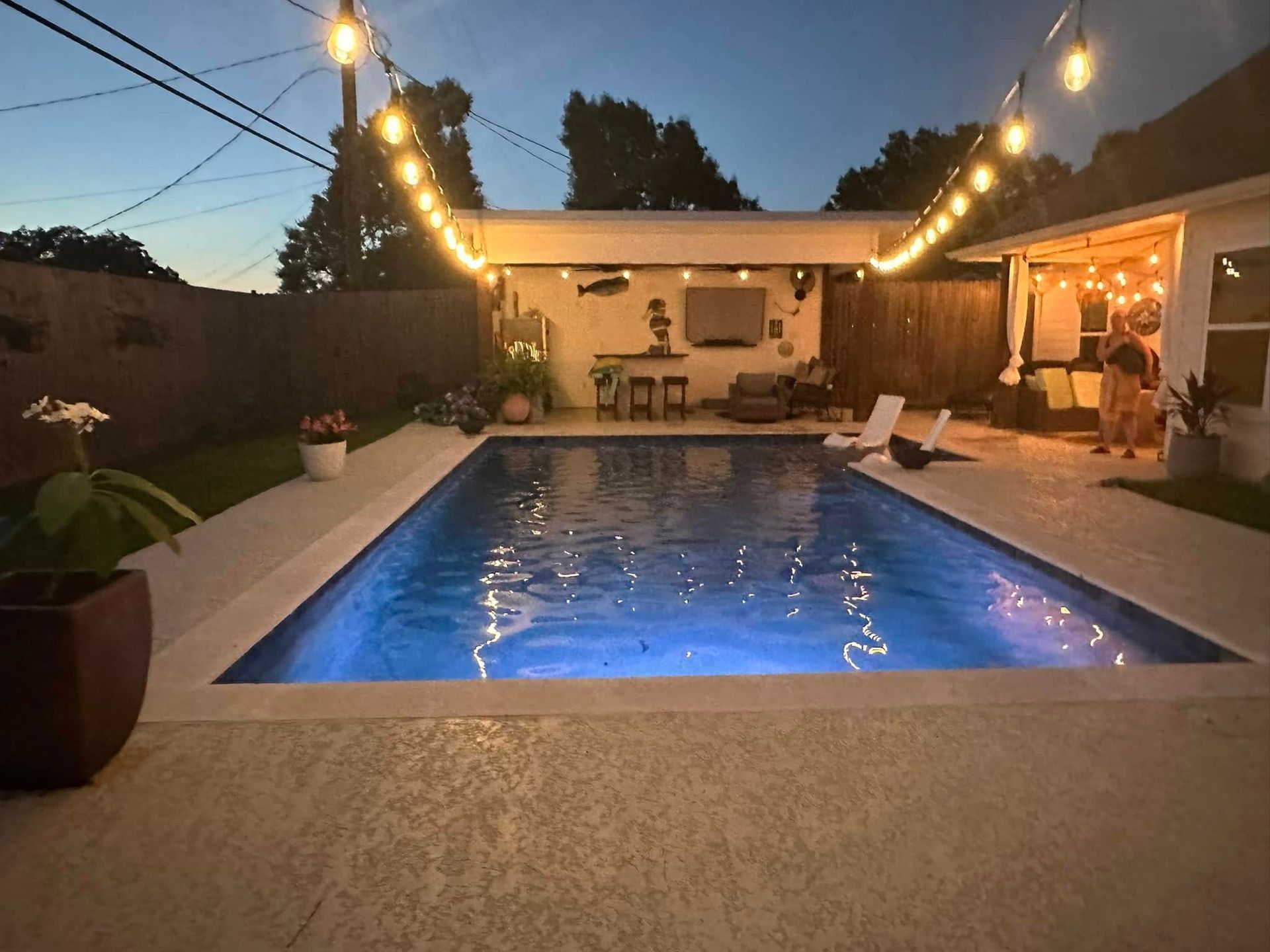 A large swimming pool is lit up at night
