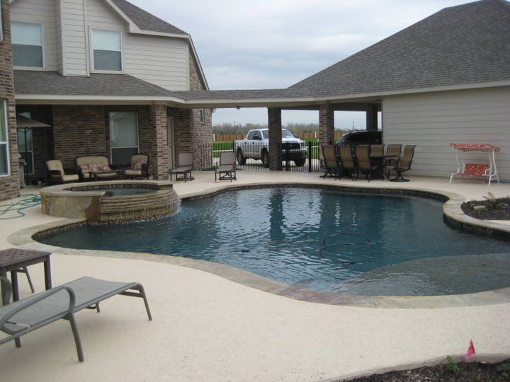 A large swimming pool in the backyard of a house