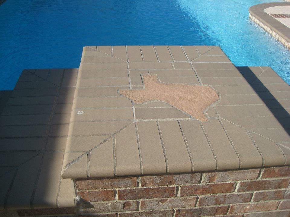 A brick walkway leading to a swimming pool