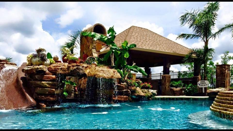 There is a waterfall in the middle of the pool.