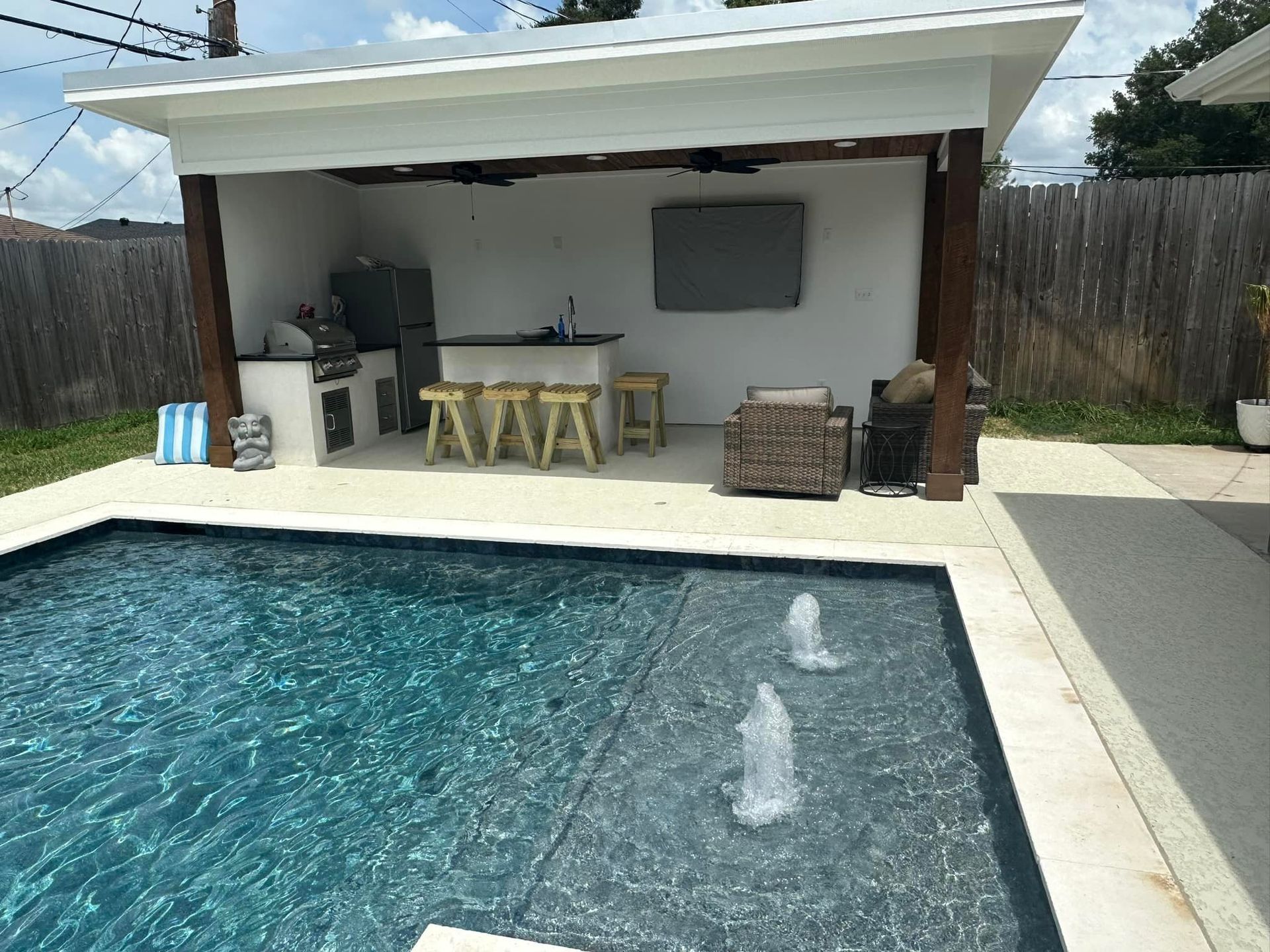 A large swimming pool with a gazebo in the backyard