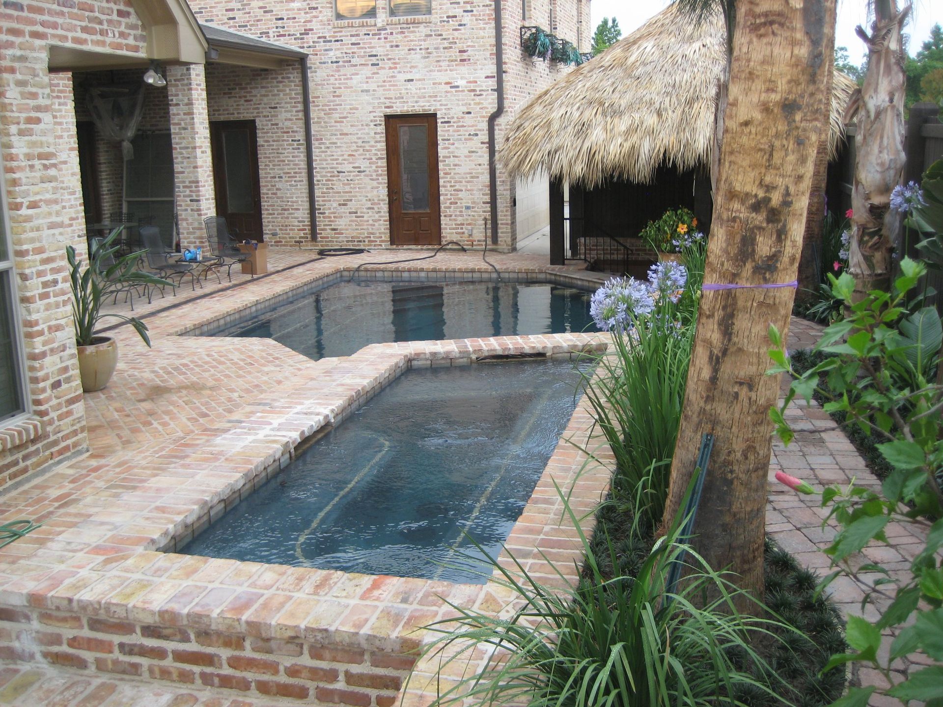 A large swimming pool in the backyard of a house