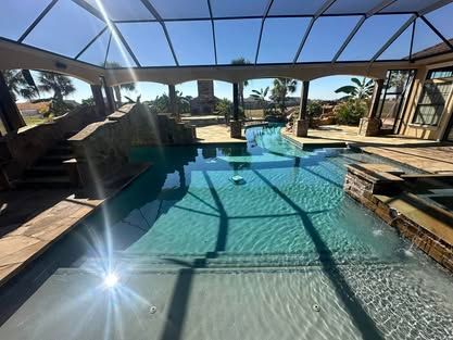 A large indoor swimming pool with a screened in area