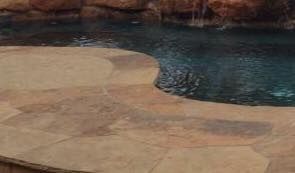 There is a waterfall in the middle of the pool.