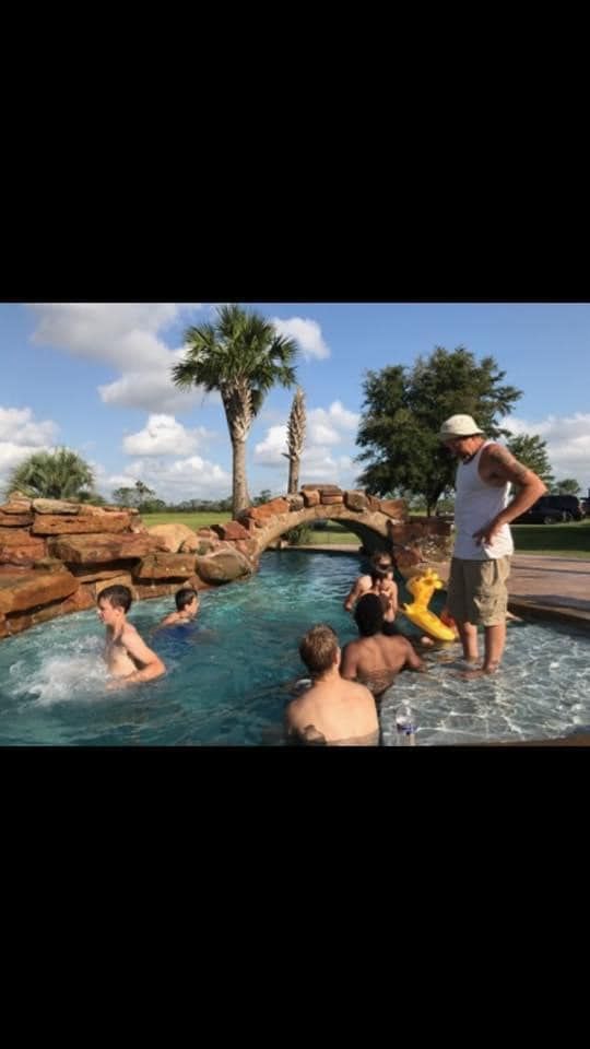 A group of people are playing in a swimming pool.