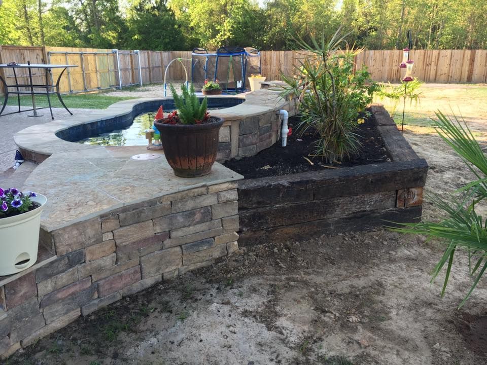 A patio with a swimming pool and a table and chairs in the background.