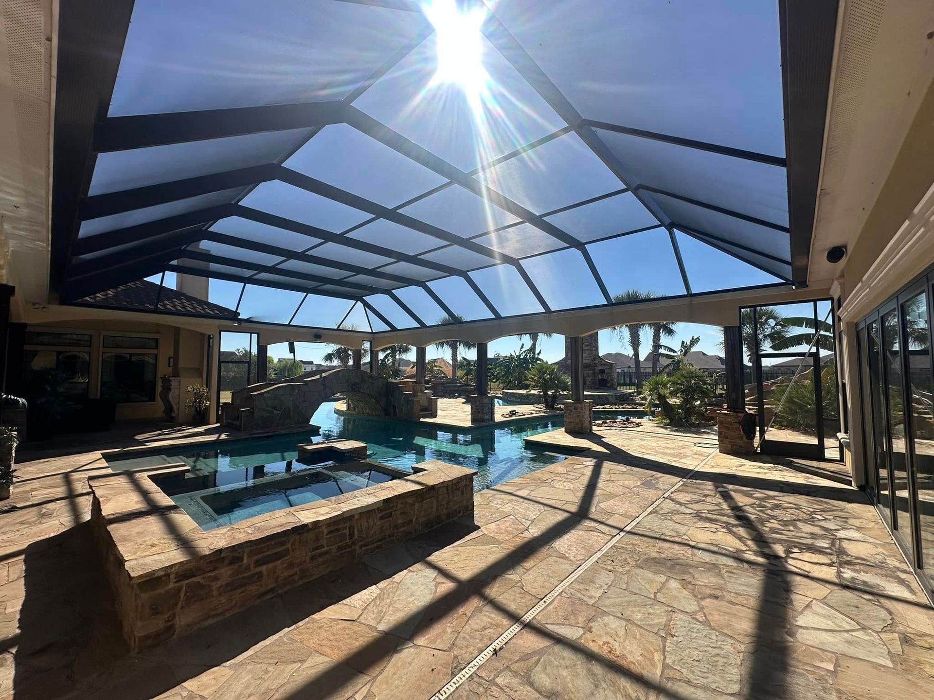 The sun is shining through the roof of a pool house.