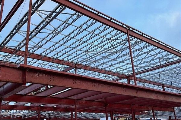 Metal roof framing of a building under construction.