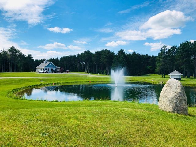 a pond with a fountain in the middle of it