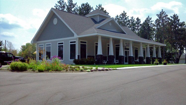 a large house with a large porch and a truck parked in front of it