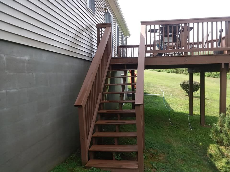 A wooden deck with stairs leading up to it