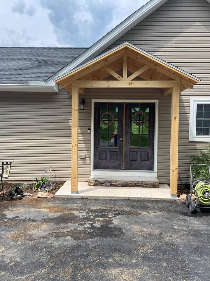 A house with a wooden porch over the front door.