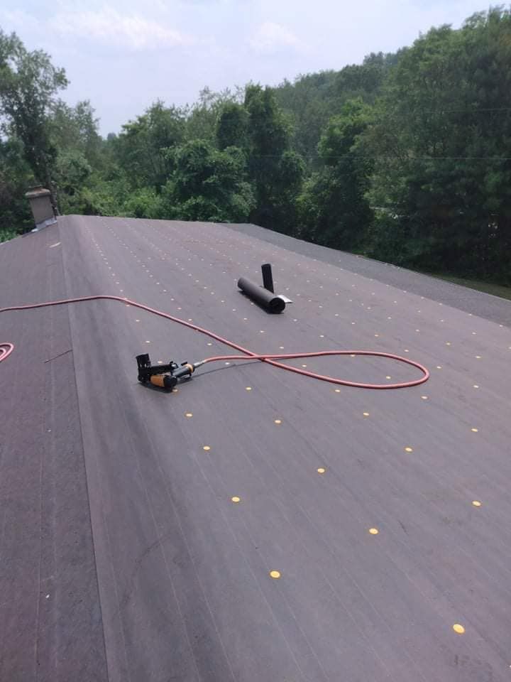 A roof with a hose and a tool on it.