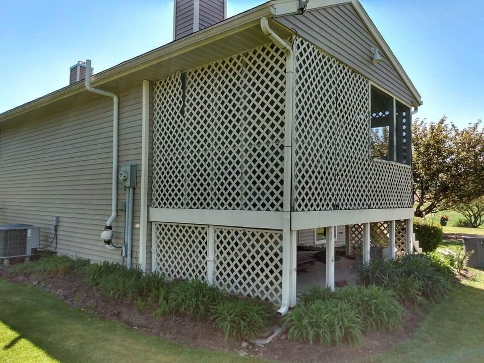 The side of a house with a lattice covering