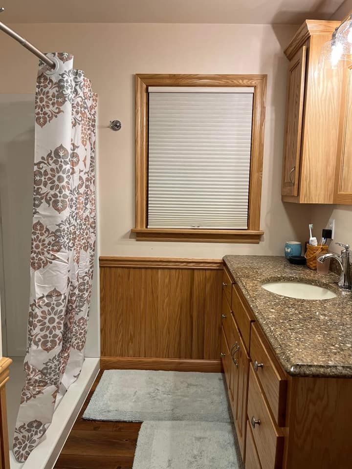 A bathroom with a sink and a shower curtain