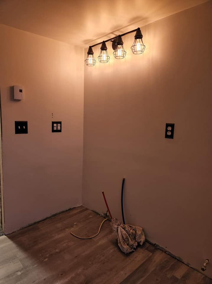 A room with a mop and lights on the wall.