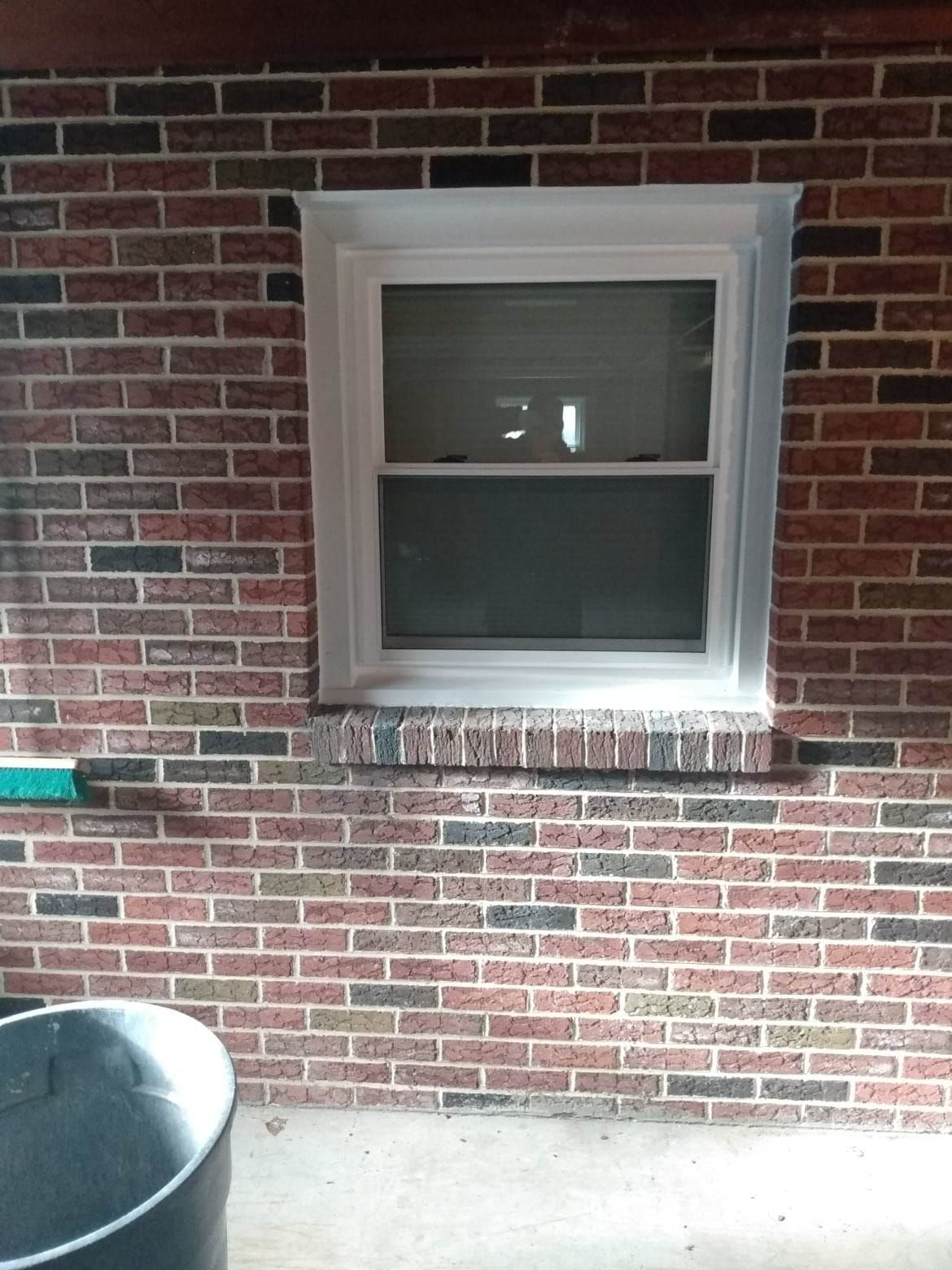 A brick wall with a window on it
