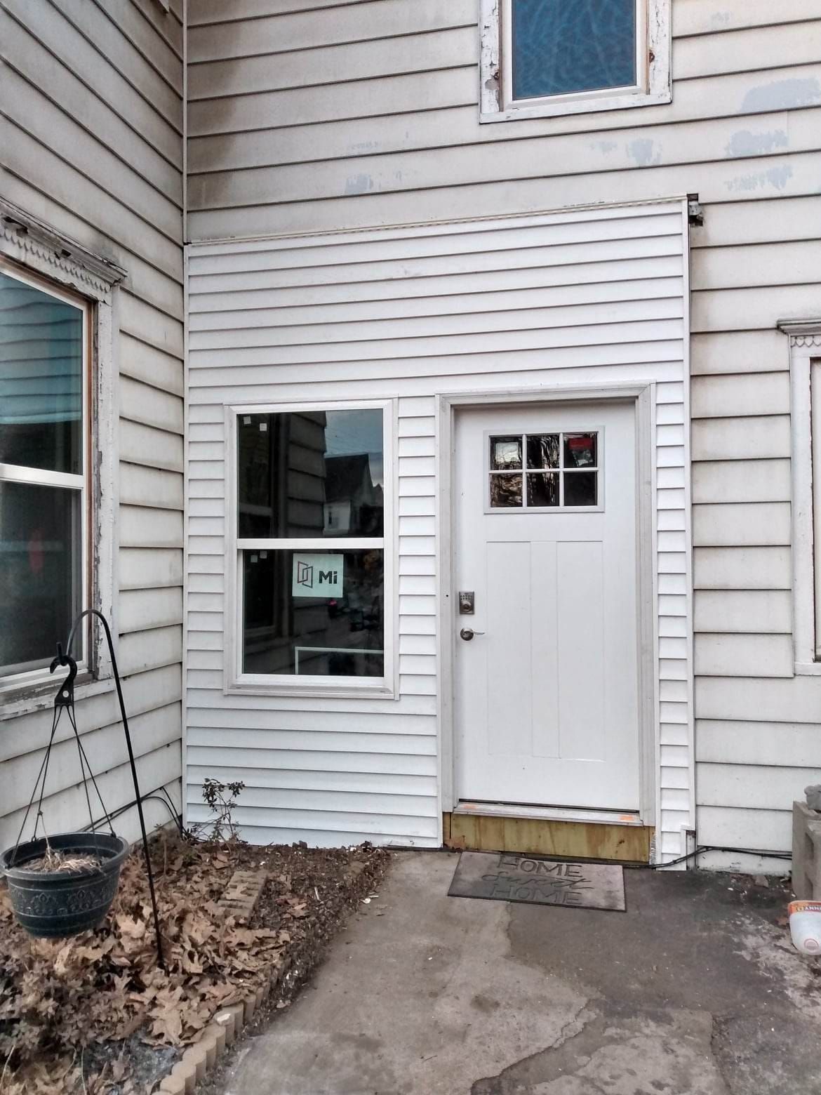 A white house with a white door and a window