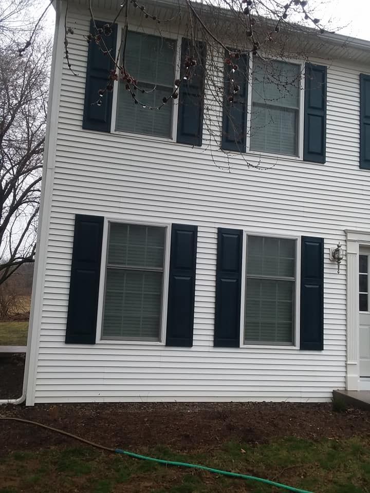 A white house with black shutters on the windows
