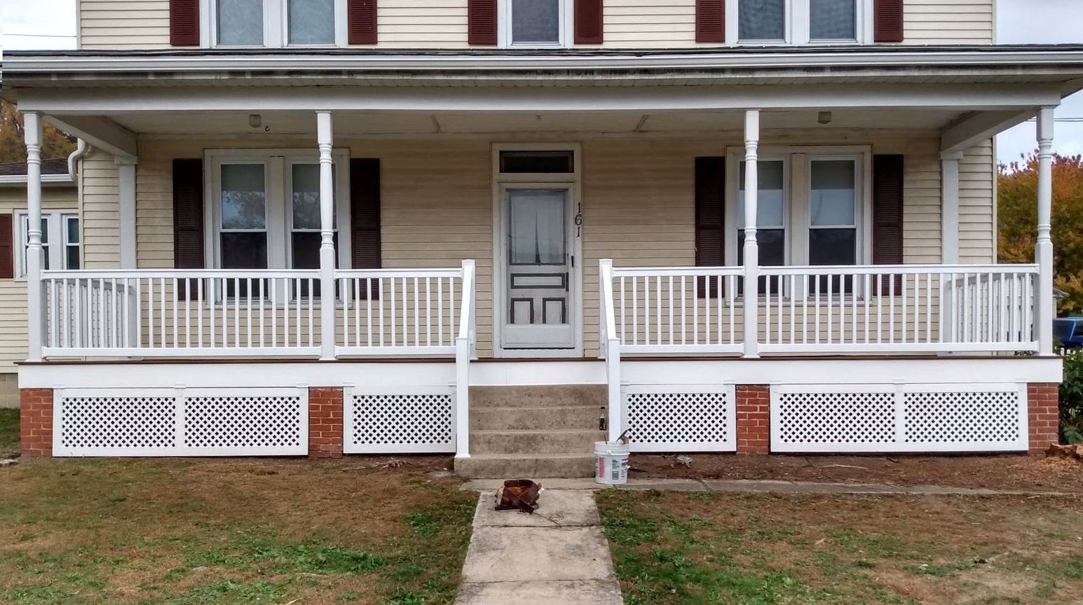The front of a house with a porch and stairs