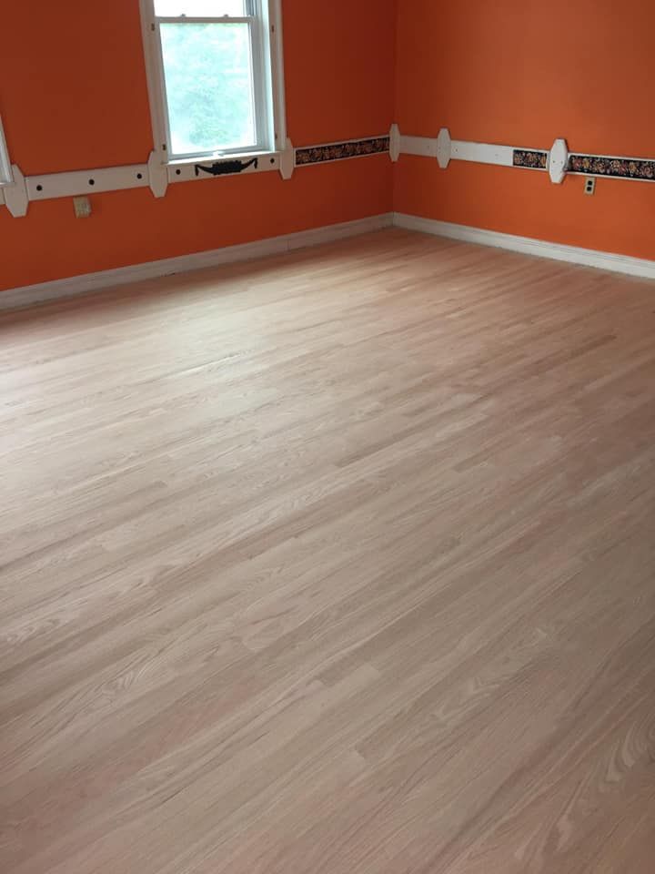 A room with a wooden floor and orange walls.