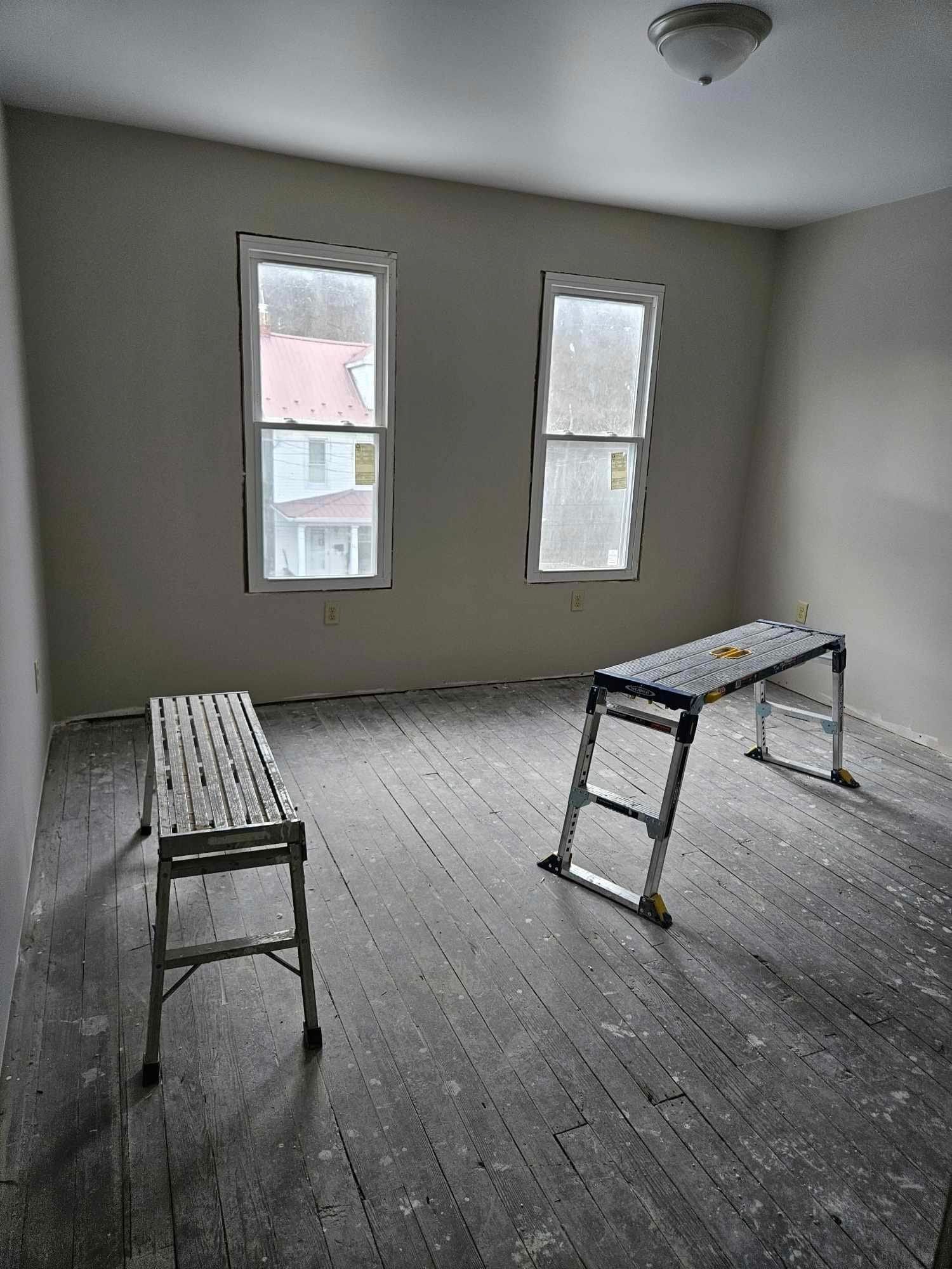 A room with two ladders and two benches in it.