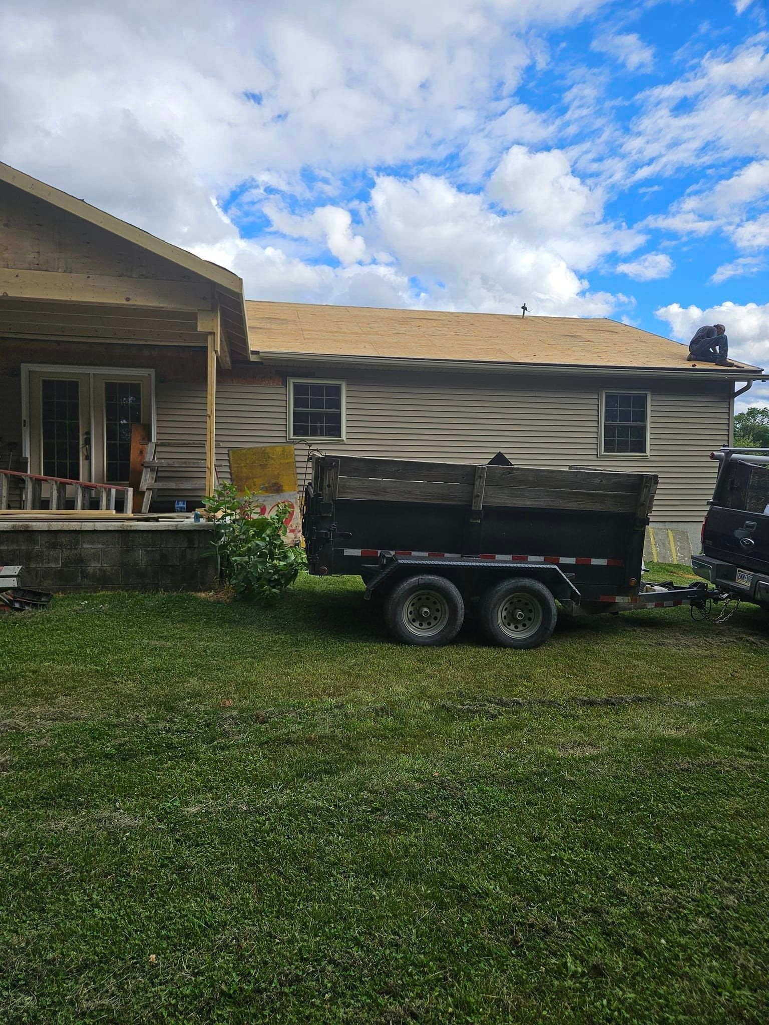 A dump truck is parked in front of a house.