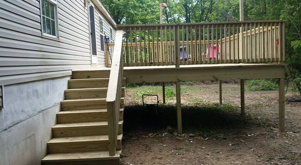 A wooden deck with stairs leading up to it