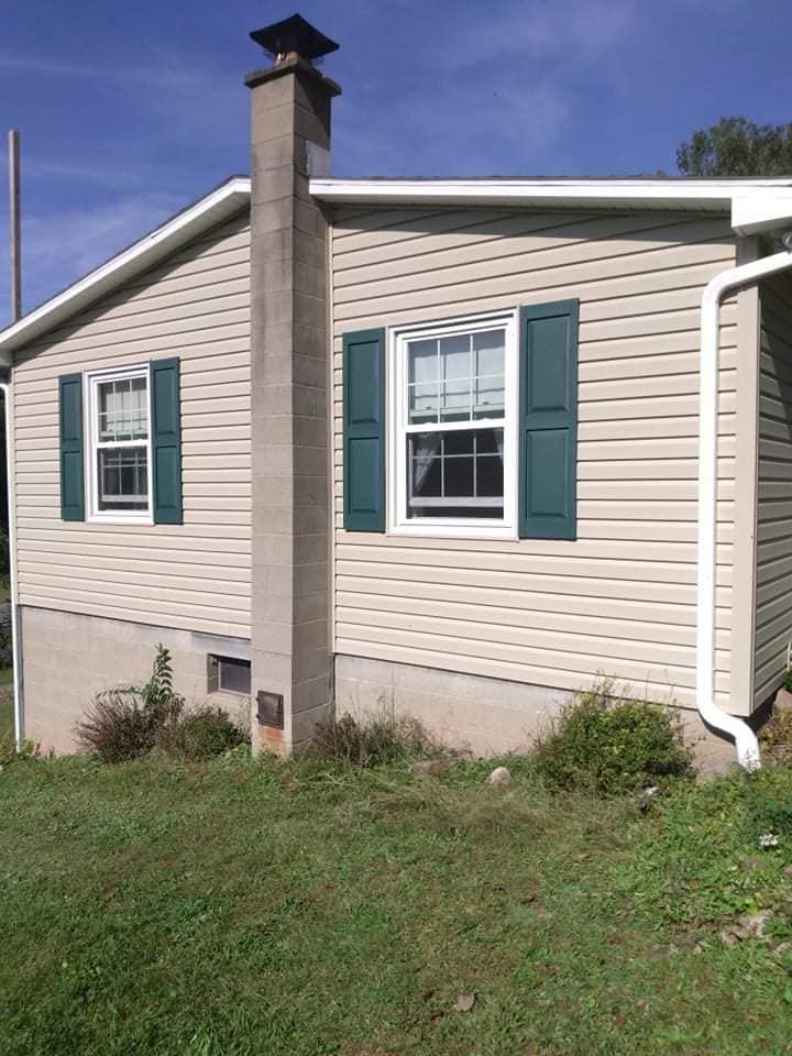 A house with green shutters and a chimney