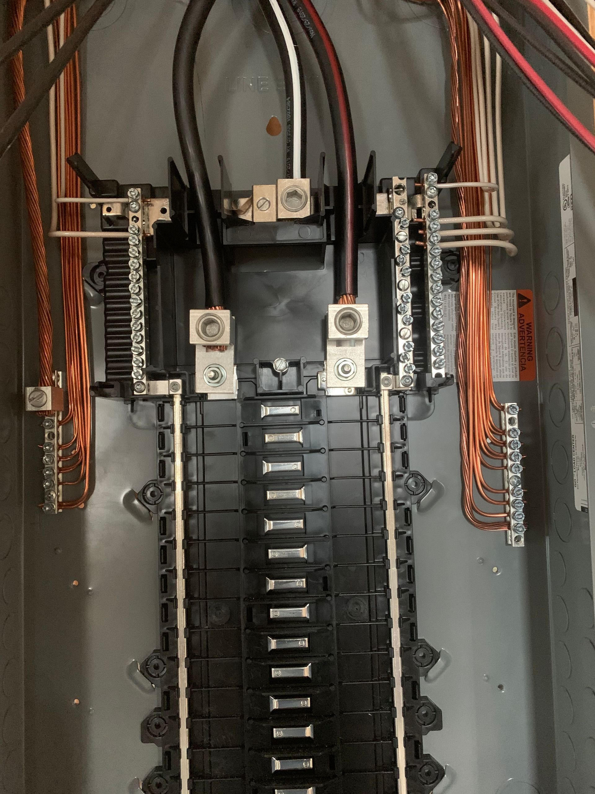 Electrical panel interior with copper wiring and terminals.