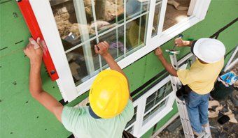 Men fixing glass window