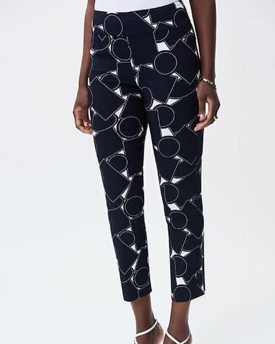 A woman is wearing a pair of black pants with a white pattern on them.