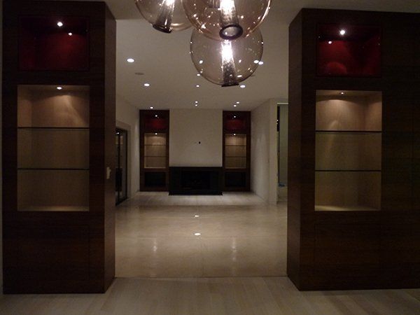 A room with a lot of shelves and a ceiling light