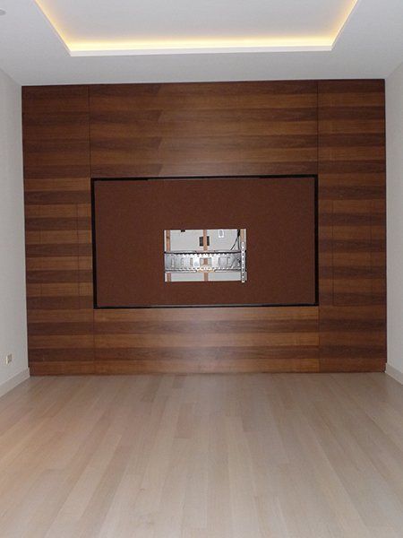 An empty room with a large wooden wall