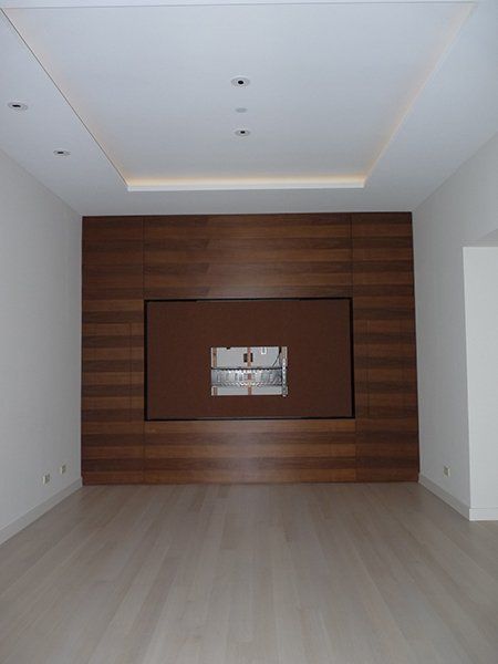An empty room with a tv mounted on the wall
