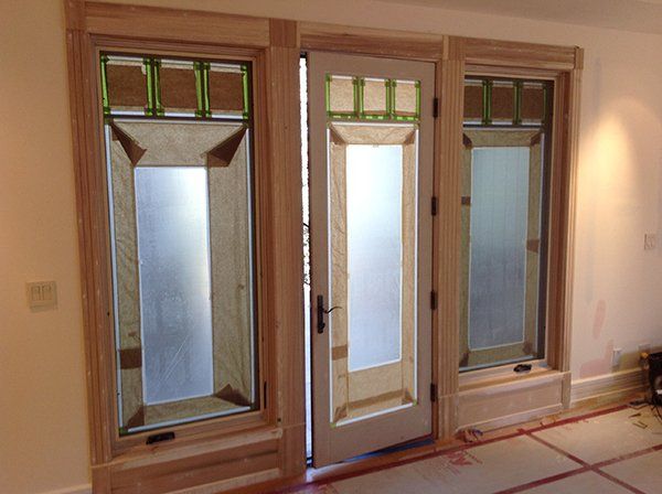 A room with three windows and a door 