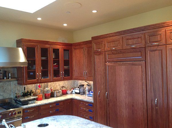 A kitchen with wooden cabinets 