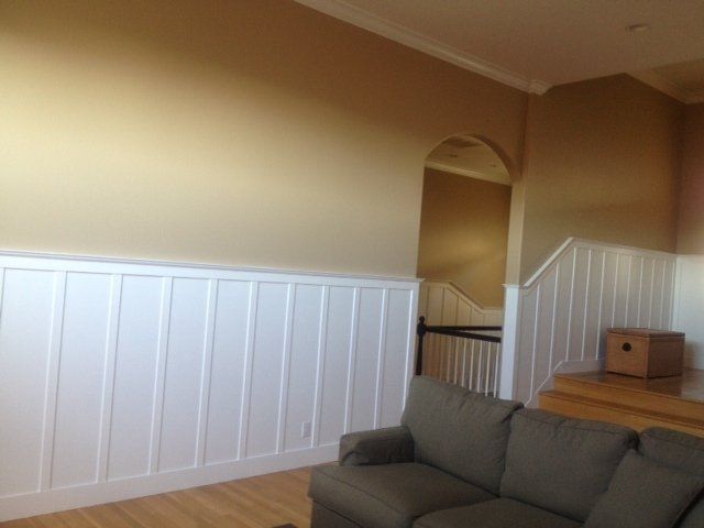 A living room with a couch and stairs 