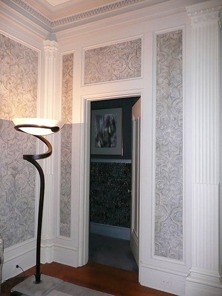 A room with a lamp and a doorway 