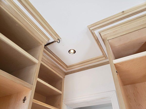 A walk-in closet with wooden shelves 