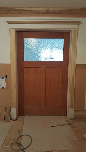 A wooden door with a glass window 