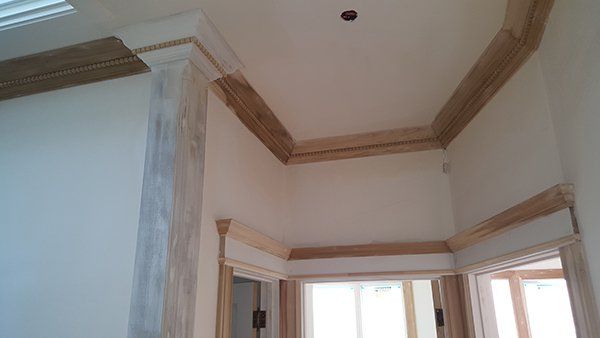 A hallway with a ceiling and molding 