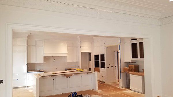 A kitchen with white cabinets