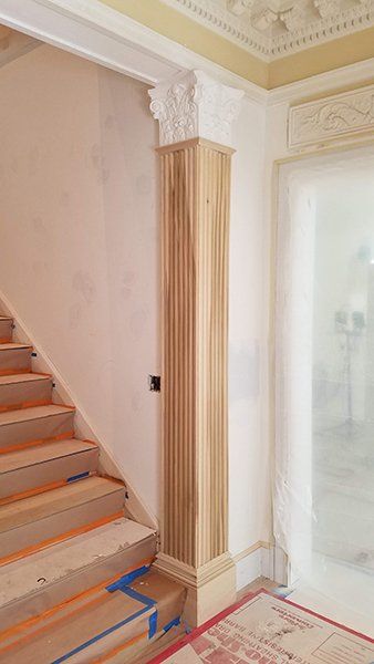 A wooden staircase with a wooden column 