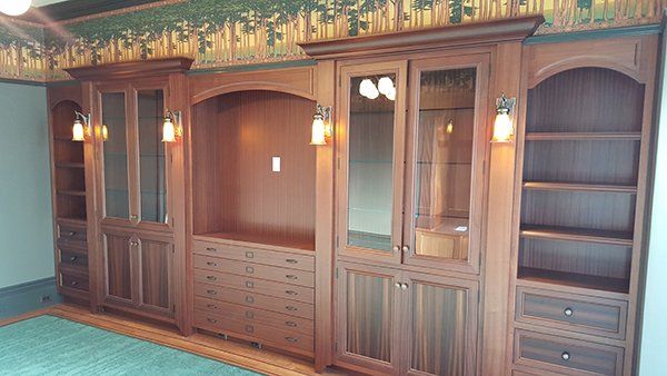 A room with a wooden cabinets and shelves