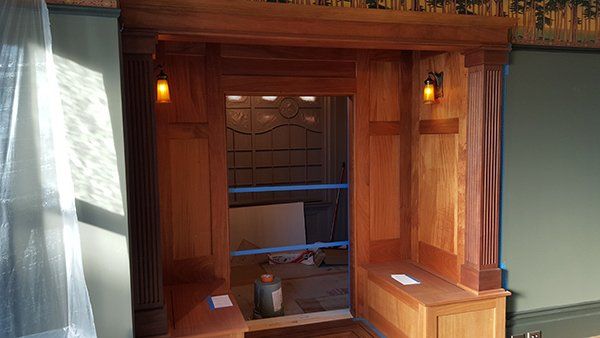 A room with a wooden wall and a wooden bench