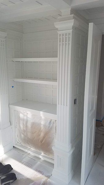 A white cabinet with shelves