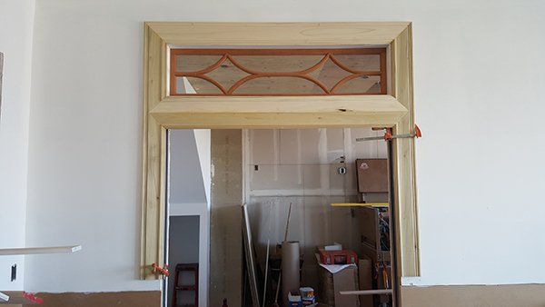 A door is being built in a room with a window