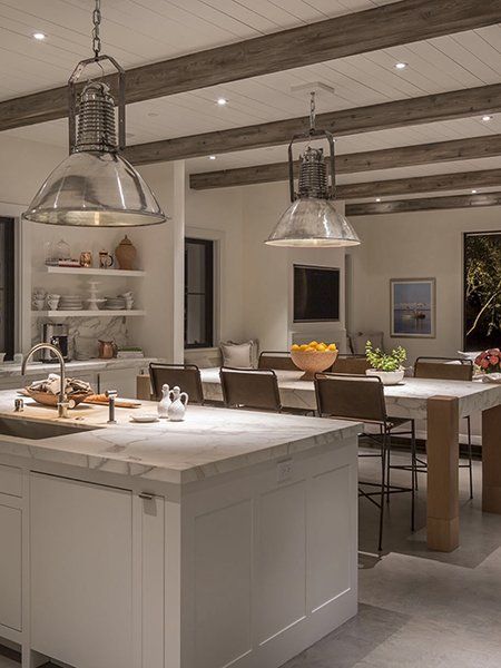 A kitchen with a large island and a dining table