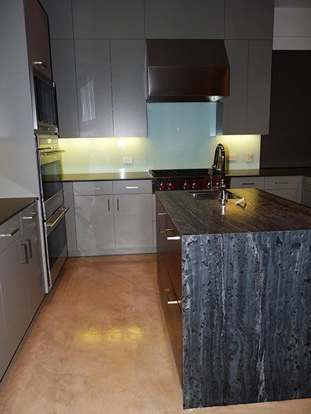 A kitchen with a large island in the middle